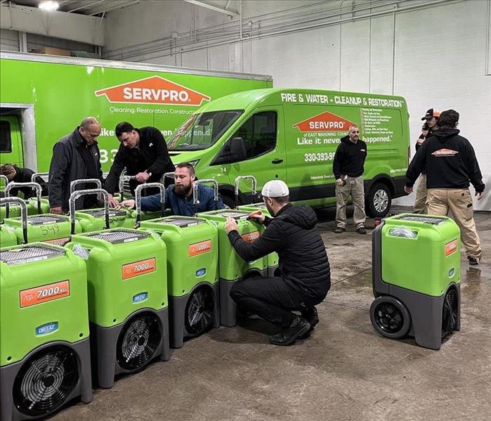 SERVPRO employees inventorying new equipment in warehouse